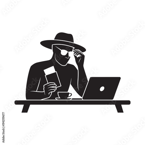 A person with a hat works on a laptop with coffee and a card