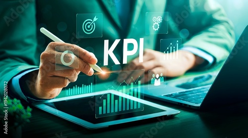 Business professional analyzing KPI data on laptop with futuristic digital interface and growth charts in modern office