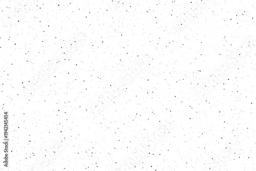 Countless tiny dark specks are broadly distributed across a brilliant white canvas