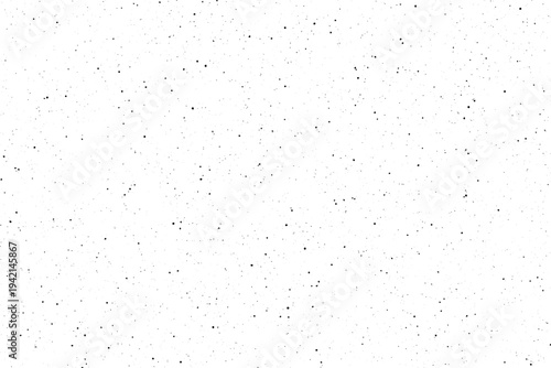 Numerous tiny black dots are scattered randomly across a bright clean white surface