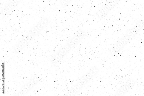 Many small dark flecks appear spread out on a bright white canvas surface
