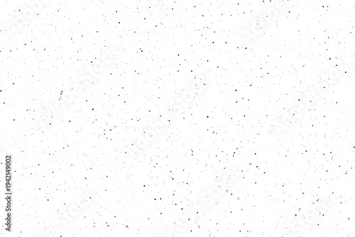 Tiny black specks randomly spread across a pristine white surface creating a subtle overlay