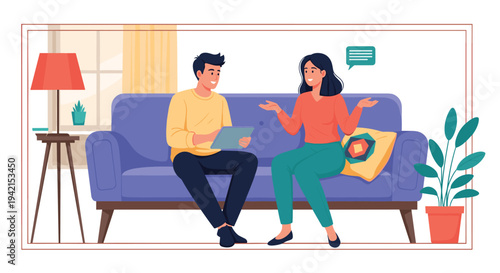 Young couple relaxes on a blue sofa in their living room while discussing something interesting on a portable digital tablet.
