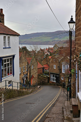 View of Robin Hood's Bay from New Road hill; historic fishing village in North York Moors National Park, North Yorkshire with red tiled roofs, steep streets, coastal landscape, North Sea, England