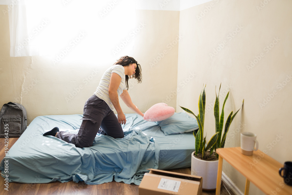 Fototapeta premium Hispanic woman setting up first apartment, celebrating independence despite financial struggles and making ends meet