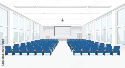 A large, empty auditorium with numerous rows of dark blue upholstered seats faces a prominent white projection screen within a spacious room.