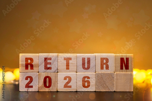 Photography Financial tax return 2026 concept with wooden blocks on warm bokeh background