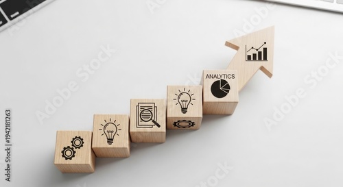 A series of wooden blocks with business and growth symbols on a white background with a blurred effect