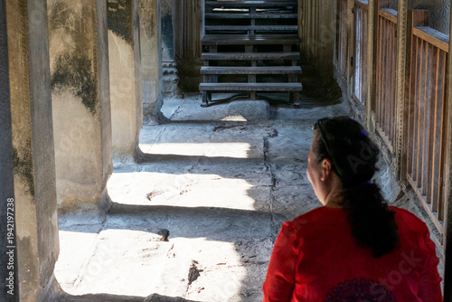 Tourist exploring ancient angkor wat temple interior