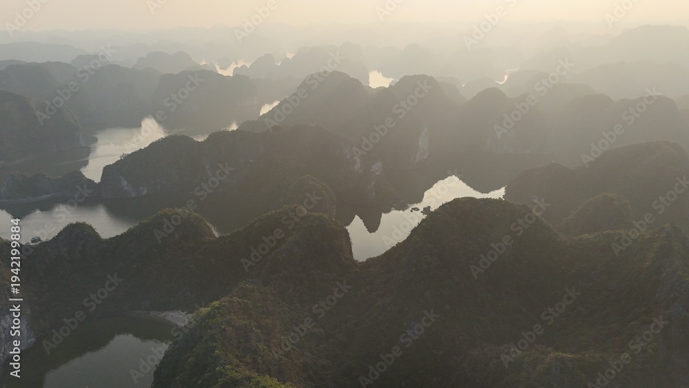 Αυτοκόλλητο Beautiful sunrise over Ha Long Bay with limestone karst islands rising from the emerald water, traditional boats sailing between the cliffs in northern Vietnam