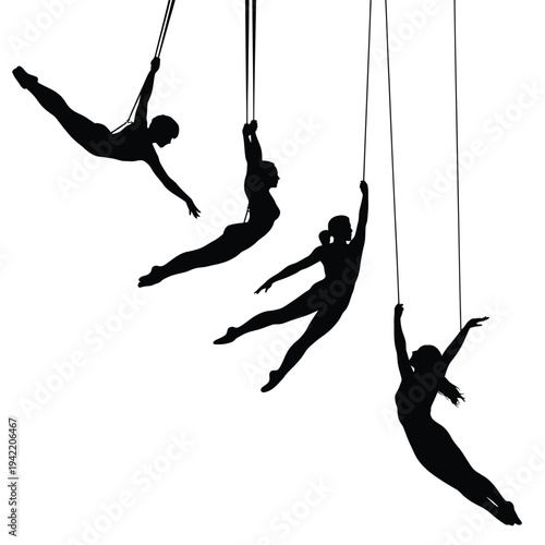 Silhouettes of aerialists performing dramatic poses on hanging ropes and cords