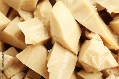 Pieces of natural cocoa butter as background, closeup