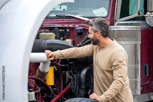 Trucking owner. Truck driver. Man trucker driver near lorry truck. Transportation vehicles. Semi trucks vehicle. Hispanic man trucker. Handsome man driver in front of truck. Driving route