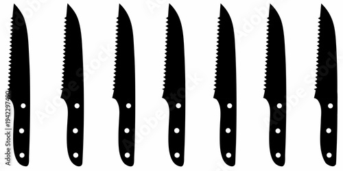 A collection of black steak knives arranged in a horizontal row