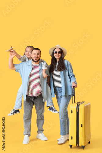 Family of travelers with su...