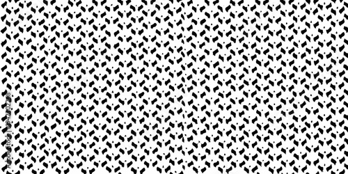 Abstract black and white pattern resembling scattered brushstrokes or seeds