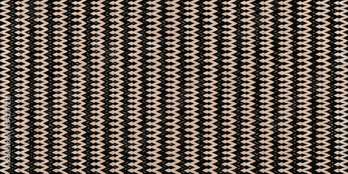 Close up of a woven straw surface with a geometric zigzag pattern