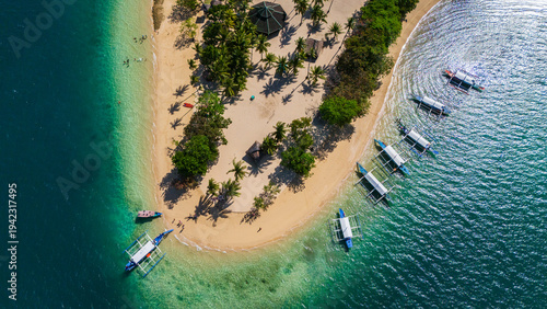 Aeria top donwnl drone shot of the tropical Cowrie Island in Honda Bay, Puerto Princesa, Palawan, Philippines