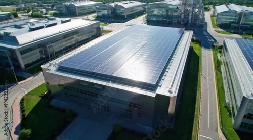 Aerial View of Modern Industrial Building with Large Rooftop Solar Panel Installation Green Renewable Energy Facility Scene 4K HD Ultra Video