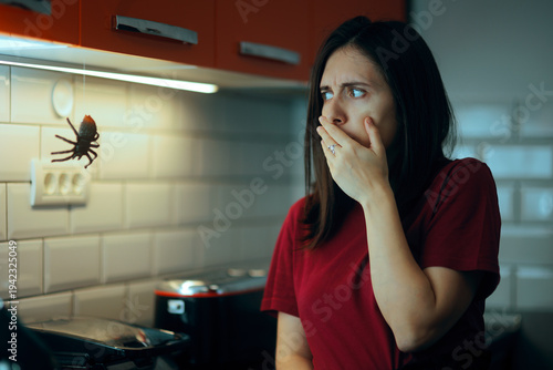 Woman Disturbed By Huge Spider in the Kitchen. Person scared by an insect in her own home