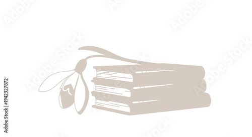 Stack of books with a delicate snowdrop flower resting on top.