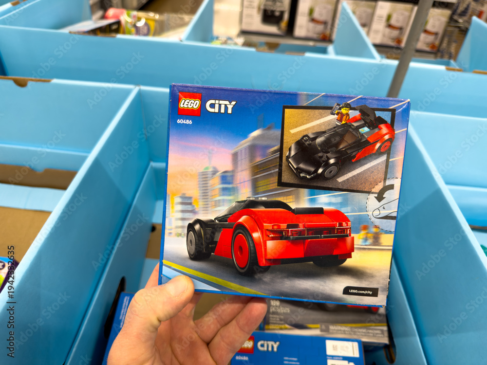 Naklejka premium LEGO City Red Sports Car Building Toy Set Box Held In Store Toy Section