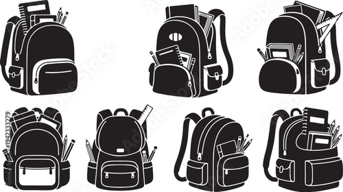 Collection of black and white backpacks with school supplies