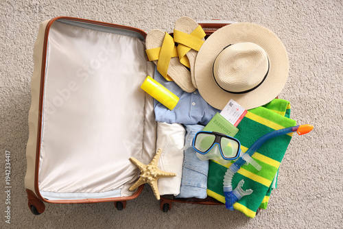 Open suitcase with clothes,...