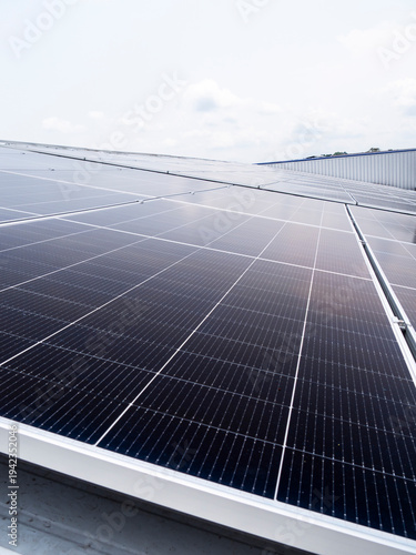 Solar panels installed on industrial warehouse roof generating renewable energy