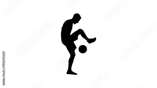 Silhouette of a soccer player juggling a ball with his knee