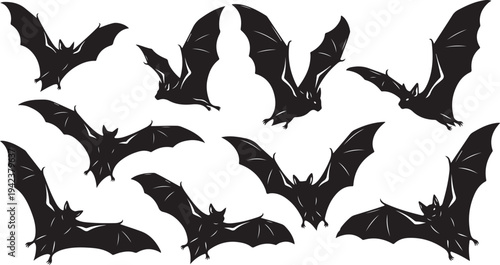Collection of black bats flying in different positions isolated