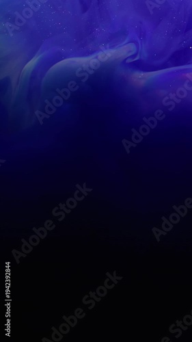 Vertical video. Shimmering dust. Defocused stream. Purple blue violet shiny paint powder swirl spill on black background. Abstract color glow water texture.