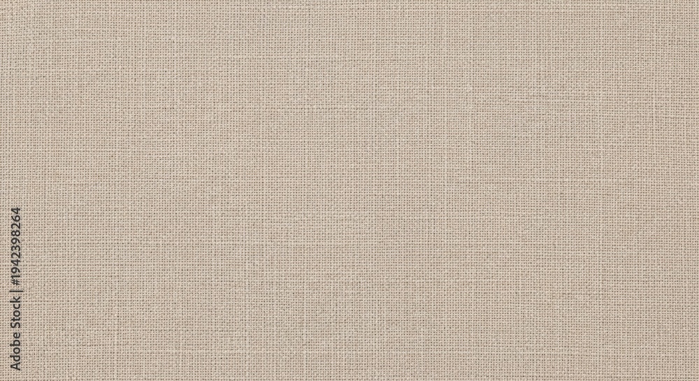 Fototapeta premium A beige textured fabric with a subtle pattern, possibly a piece of upholstery or a curtain material.