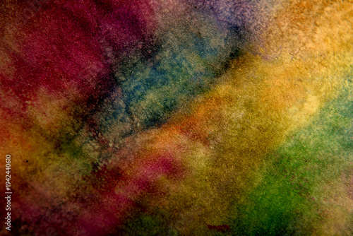 
Dark background of stains on multi-colored paper