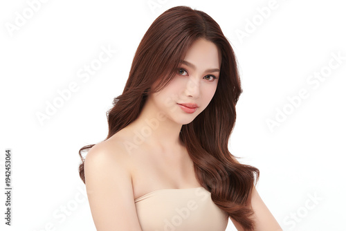 A beautiful young Asian woman with clean, fresh skin against a white background. Skincare, facial treatment, cosmetology, beauty, and spa. An elegant portrait of an Asian woman.