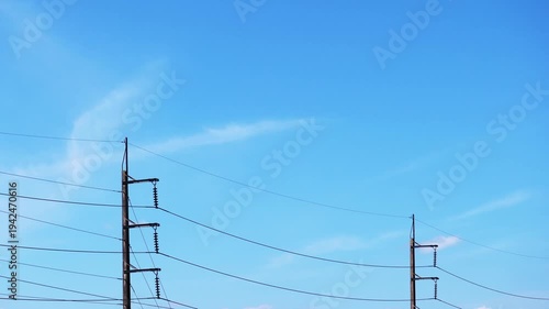 High voltage Electricity power line on beautiful clear sky background with white cloud or cirrus cloudscape in tropical summer sunlight n sun ray, daylight sunny sunshine day, 4k Stop motion TimeLapse