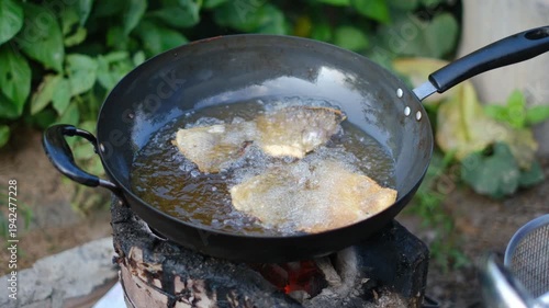 Cooking Delicious Fried Fish on Outdoor Stove with Traditional Techniques and Fresh Ingredients for Flavorful Culinary Experiences