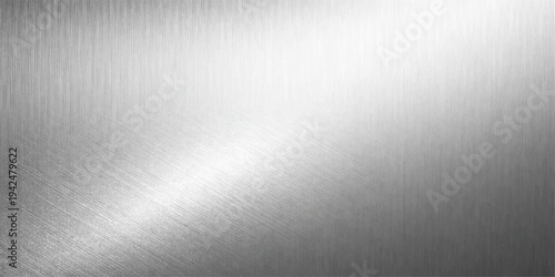A polished silver stainless steel plate features a shiny brushed metal texture with a gray metallic pattern reflecting light across the dark aluminum surface backdrop
