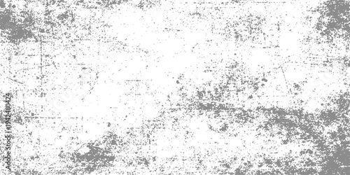 An old dirty grey concrete wall with a rough grunge texture and paint splatters creates a vintage textured stone pattern backdrop for artistic design