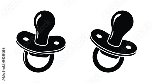 Two black pacifiers displayed against a white background a striking silhouette