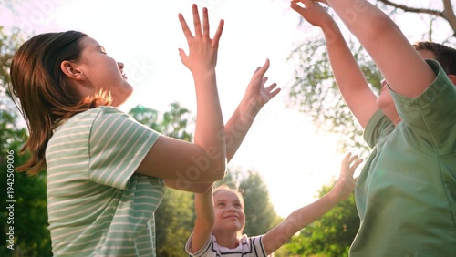 Fotografía Happy children playing playground, children hands sun glare nature, boy girl fri