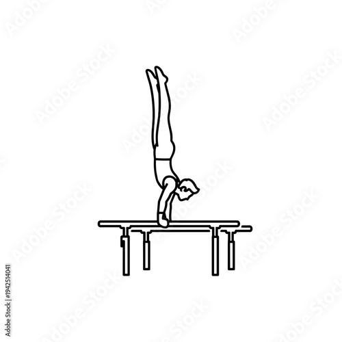 Male gymnast performing handstand on parallel bars  