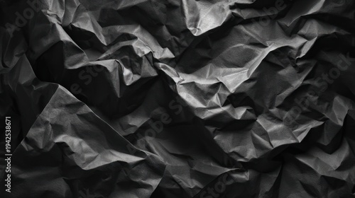 Abstract dark fabric texture with detailed folds and shadows