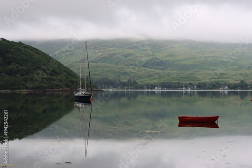 Wallpaper Mural Reflections of boats and a green misty hillside on a still sea loch Torontodigital.ca