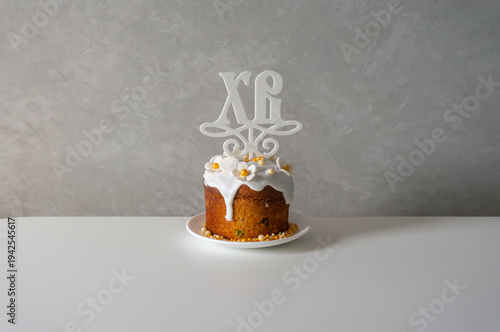 Happy Easter. Easter greeting background. Easter cake decorated with flowers and icing on a white table.