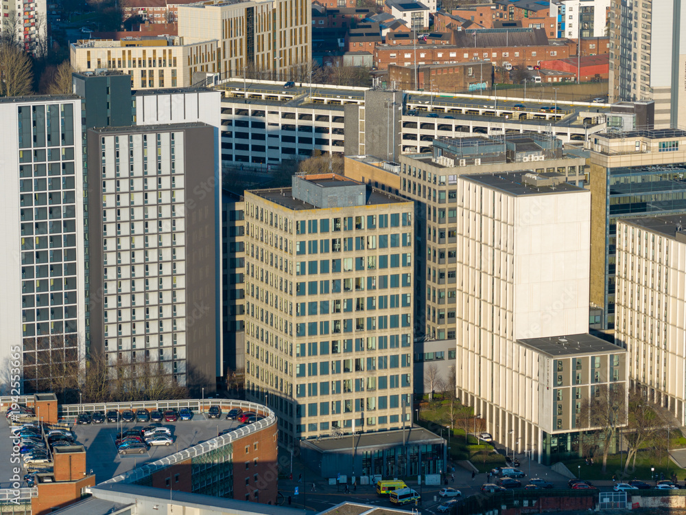 Fototapeta premium Aerial drone view of modern apartment towers and office buildings near Leeds city centre in West Yorkshire England showing contemporary urban development in the winter time