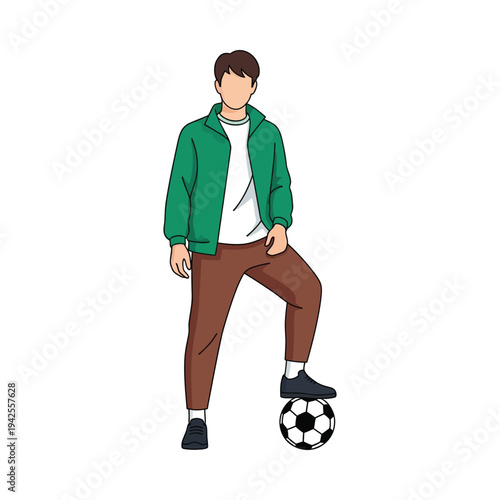 Young male soccer player resting on ball in green jacket and brown pants outdoor