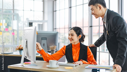 Young adult asian business people work together in office.
