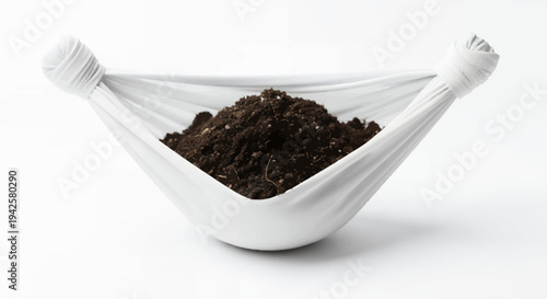 White fabric bag with rich dark soil for gardening or planting