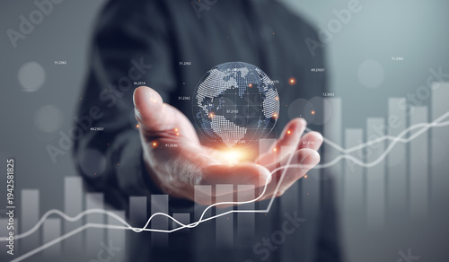 Business professional holding digital globe with financial graph overlay, symbolizing global investment, data analytics, fintech growth, and strategic market expansion in modern economy.